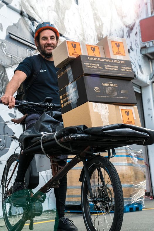 Bike courier with a stack of garage project